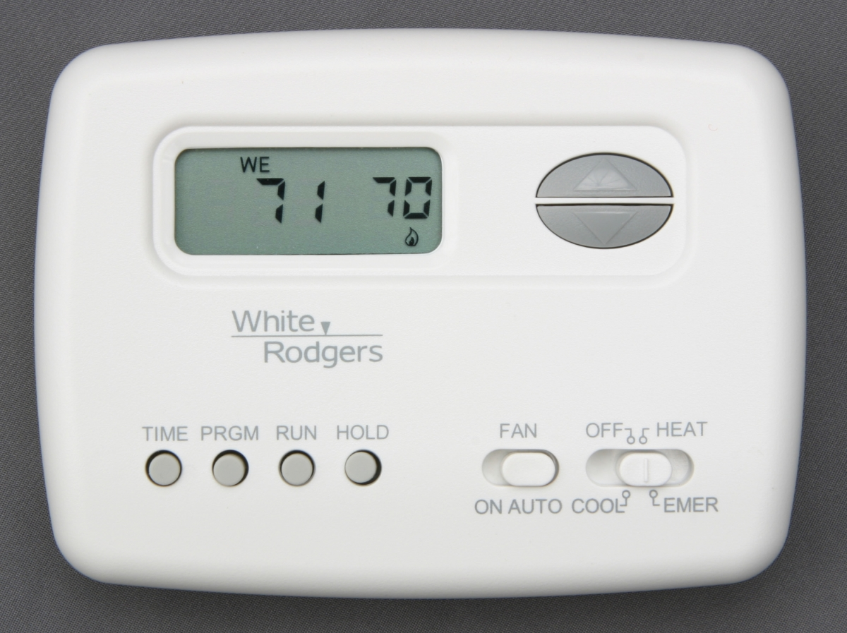 Close-up of a White-Rodgers digital thermostat set to 71°F with options for fan control, temperature adjustment, and heating/cooling modes—representing a system installed by A-1 Guaranteed Heating & Air, Inc. in Novato, CA.